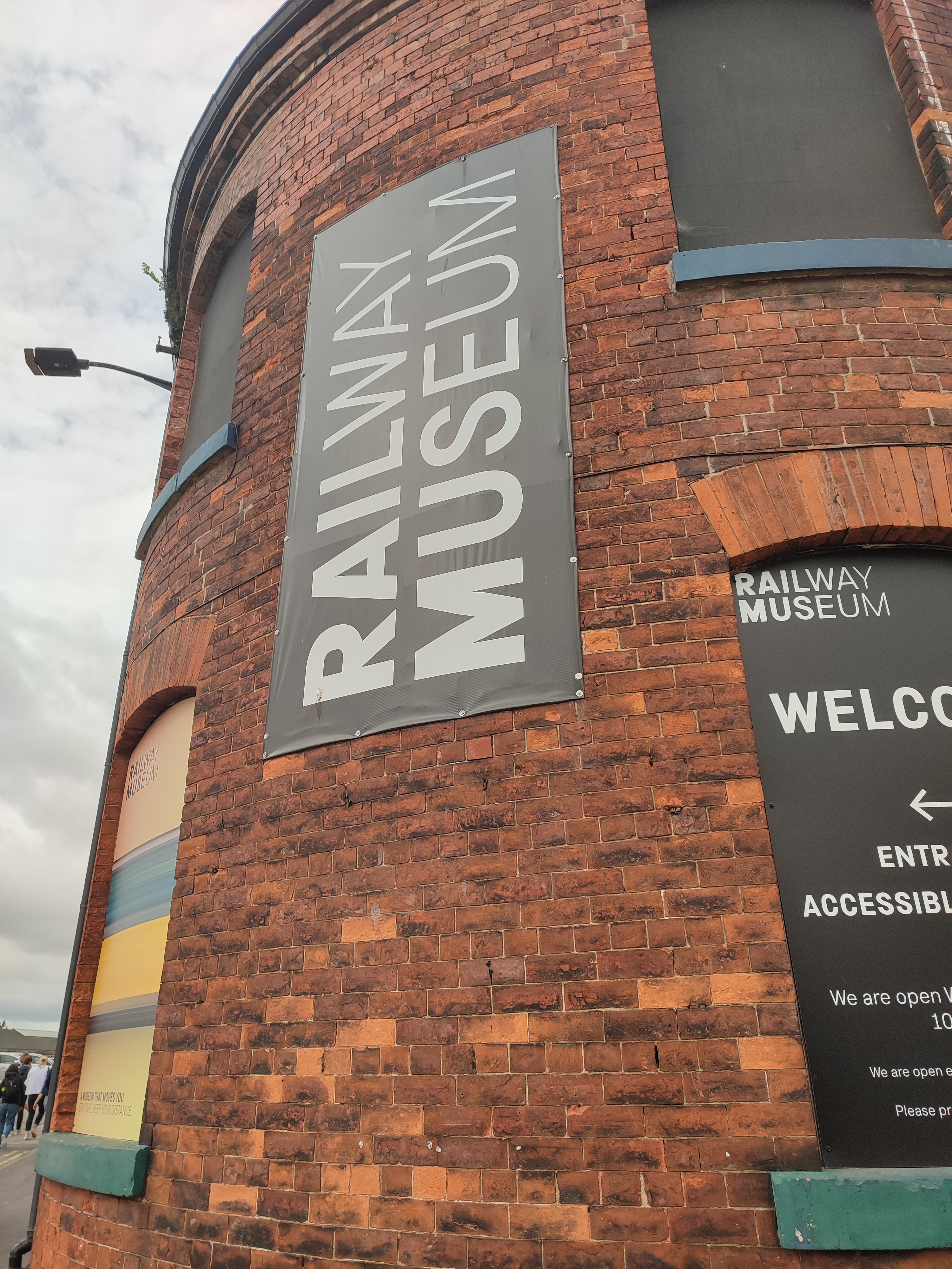 Black Railway Museum Sign on the side of a curved red brick wall